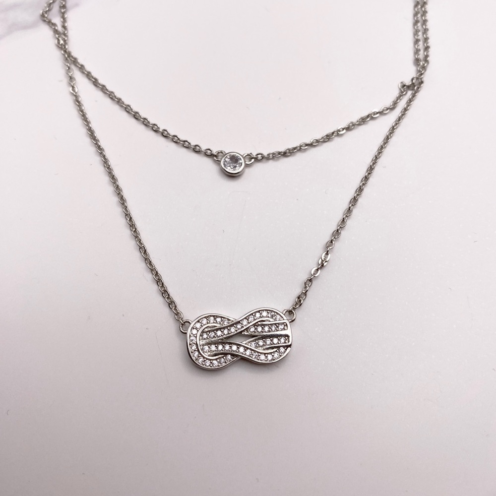 Double layered sterling silver love knot and cz necklace